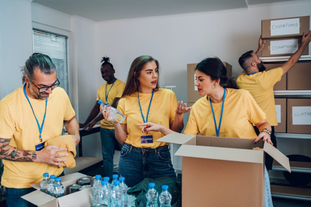 Group of multiracial volunteers working in community charity donation center